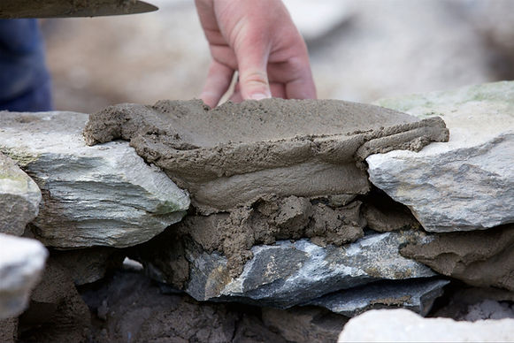 Hand-built natural stone retaining wall masonry